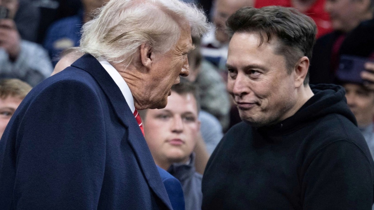 Elon Musk greets US President Donald Trump as he arrives to watch the men's NCAA wrestling competition.